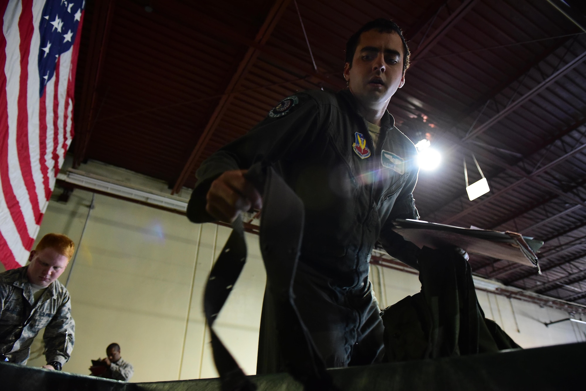 1st Lt. Justin Murray, 335th Fighter Squadron pilot, grabs a web belt before simulating a deployment during exercise Thunderdome 17-02, July 20, 2017, at Seymour Johnson Air Force Base, North Carolina. The exercise required the 4th Fighter Wing to prepare and deploy more than 400 Airmen and more than 300 tons of cargo and equipment needed to provide F-15E Strike Eagle capability and mission support to simulated regional commanders. (U.S. Air Force photo by Airman 1st Class Kenneth Boyton)