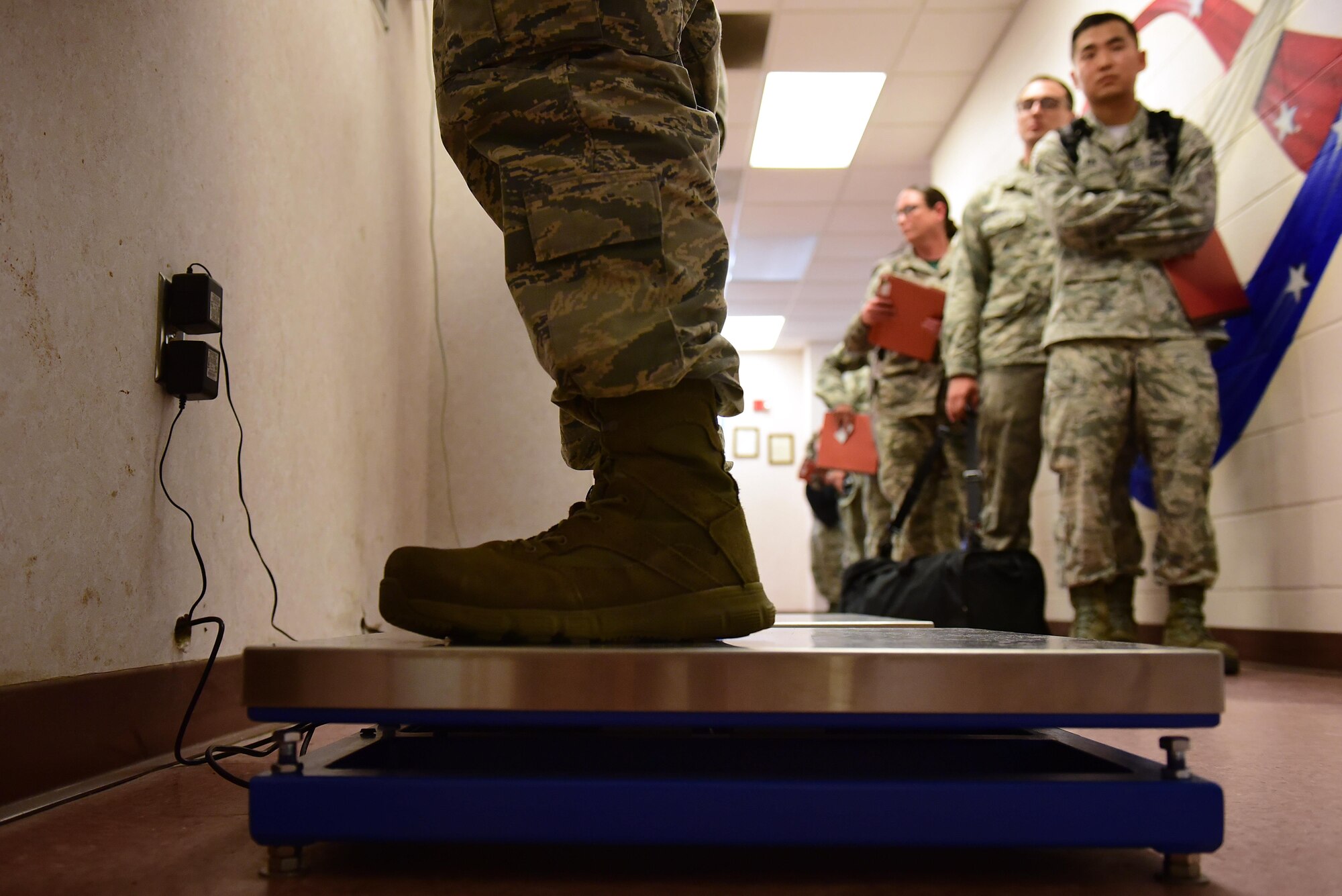 An Airman from Team Seymour stands on a weight scale while processing during exercise Thunderdome 17-02, July 20, 2017, at Seymour Johnson Air Force Base, North Carolina. During the exercise, deploying members were identified, medically cleared, equipped with any necessary gear and briefed on all information needed to conduct operations in the simulated area of responsibility. (U.S. Air Force photo by Airman 1st Class Kenneth Boyton)