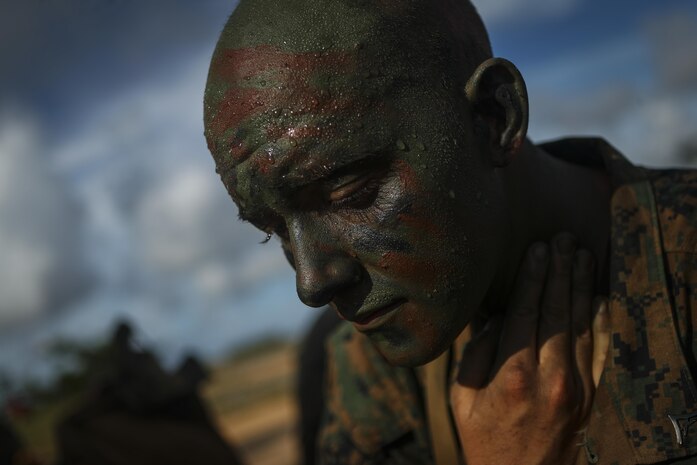 Lance Cpl. Benjamin R. Reichow, a Pontiac, Michigan native and rifleman with Alpha Company, 1st Battalion, 3rd Marine Regiment, applies camouflage paint before a helicopter insertion exercise at the Jungle Warfare Training Center aboard Camp Gonsalves, Okinawa, Japan, July 17, 2017. The Jungle Warfare Training Center provides individual and unit level training to increase survivability and lethality while operating in a jungle environment. The Hawaii-based battalion is forward deployed to Okinawa, Japan as part of the Unit Deployment Program. (U.S. Marine Corps Photo by Cpl. Aaron S. Patterson)