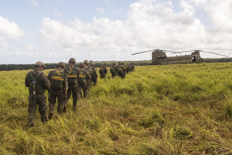 SCHOFIELD BARRACKS – Marines with 4th Force Reconnaissance Company move towards a CH-47 Chinook helicopter to conduct a static line airborne jump at Schofield Barracks, July 14, 2017. The Marines trained with U.S. Army Special Forces to maintain proficiency in completing static line and high altitude free fall airborne jumps. (U.S. Marine Corps photo by Lance Cpl. Isabelo Tabanguil)