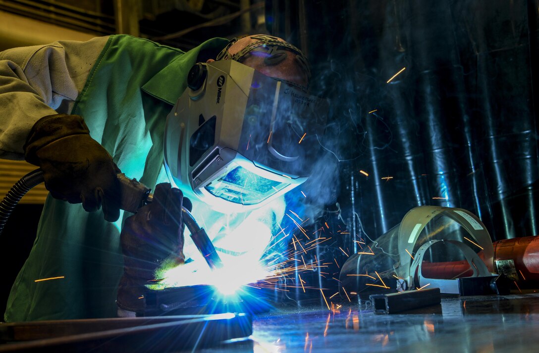 Staff Sgt. Jeffrey Kelnberger, 944th Maintenance Squadron aircraft metals technician, welds a piece of steel at Luke Air Force Base, Ariz., July 19, 2017. Airmen in the metals technology shop have several variants of welding machines, manual and computer operated lathes, milling machines, saws, grinders and drill presses to assist them in repairs. (U.S. Air Force photo/Airman 1st Class Caleb Worpel)