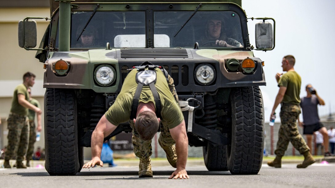 A Marine pulls a Humvee at a USO field meet and cookout for Marines at Air Station Iwakuni in Yamaguchi, Japan, July 21, 2017. The event included other competitions. Marine Corps photo by Lance Cpl. Jacob A. Farbo