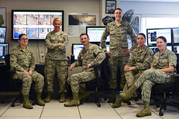 U.S. Airmen from the 25th Operational Weather Squadron pose for a photograph at Davis-Monthan Air Force Base, Ariz., July 19, 2017. The 25th OWS works 24 hours a day and seven days a week by monitoring the base’s weather conditions and their potential effects on operations. (U.S. Air Force photo by Airman 1st Class Michael X. Beyer)