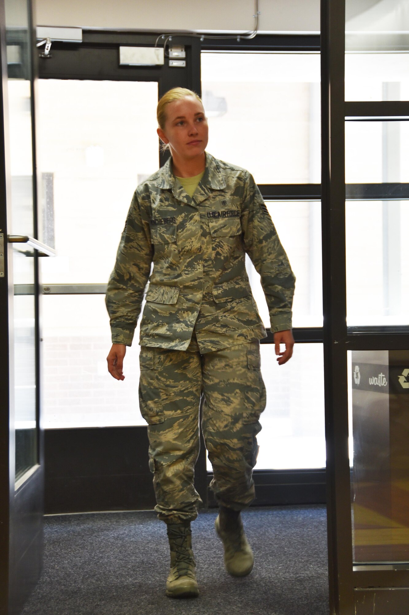 Senior Airman Camillia Muncheberg, 931st Aerospace Medicine Squadron medical technician, walks through the doors of the 22nd Medical Group to retrieve files, July 14, 2017, at McConnell Air Force Base, Kan.  Muncheberg's medical training recently enabled her to save the life of a member of the local community.  (U.S. Air Force photo by Tech. Sgt. Abigail Klein) 