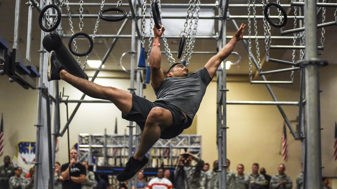 An airman reaches for a ring as he participates in a warrior course at Barksdale Air Force Base, La., July 11, 2017. The course provides obstacles to enhance fitness for civilians and service members around the world. Air Force photo by Airman 1st Class Stuart Bright