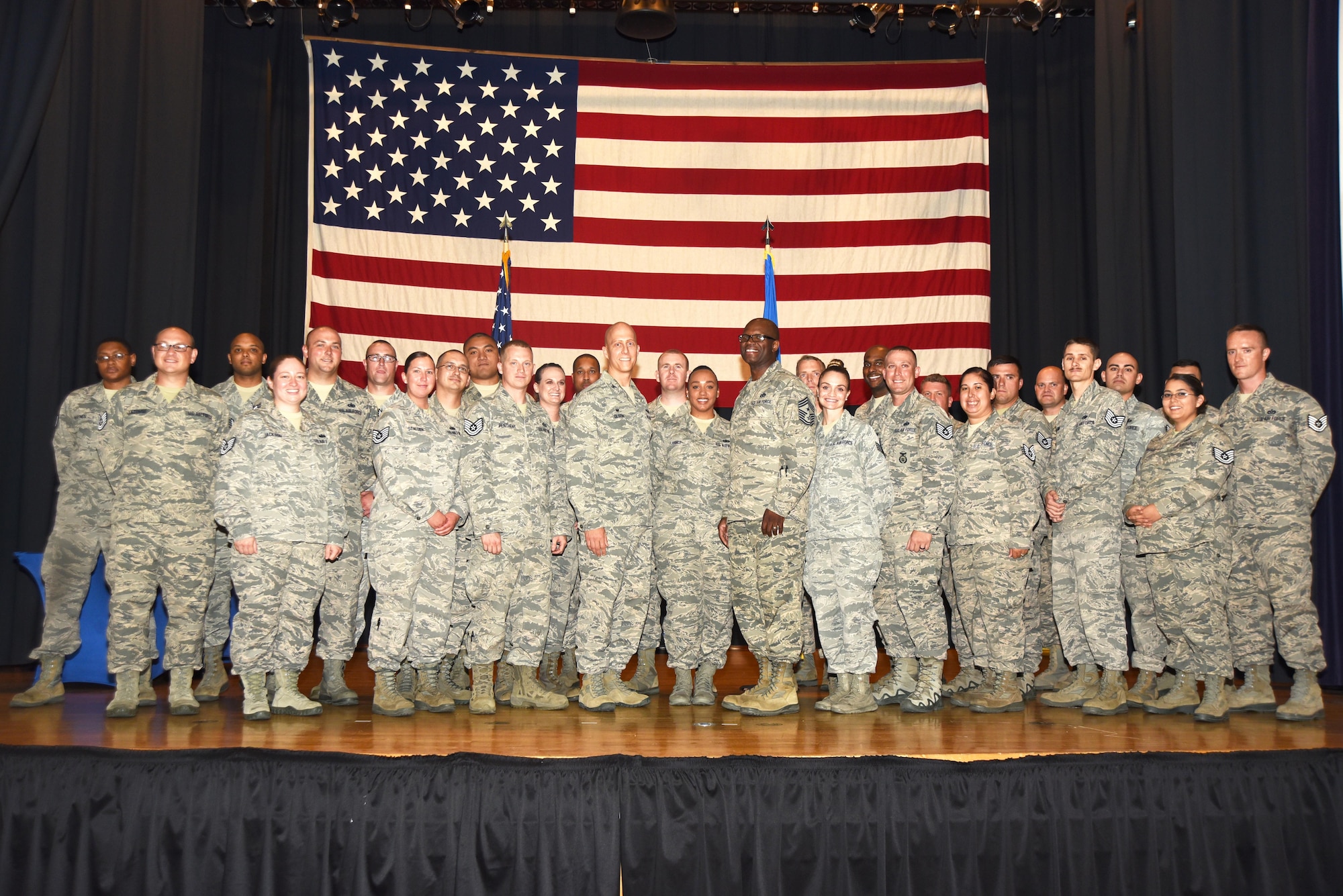 McConnell Airmen who earned promotion to technical sergeant pose for a group photo with wing leadership during a technical sergeant release party, July 20, 2017, at McConnell Air Force Base, Kan. Technical Sergeants continuously strive to further their development as technicians, supervisors and leaders. (U.S. Air Force photo/Airman 1st Class Alan Ricker)