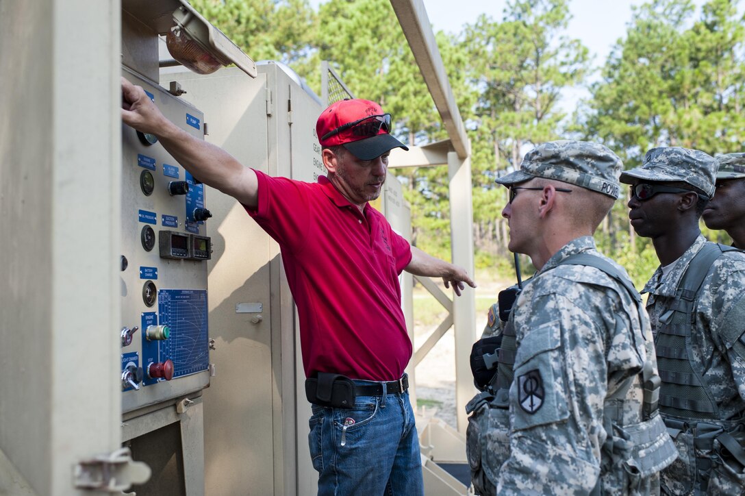 Brandon Howard, with the U.S. Army Forces Command's Petroleum Training Module, Fort Pickett, Va., discusses pump operations to U.S. Army Reserve Soldiers from the 728th Quartermaster Company, Fremont, Neb. during QLLEX 2017, July 21, at Fort Bragg, NC. QLLEX, short for Quartermaster Liquid Logistics Exercise, is the U.S. Army Reserve’s premier readiness exercise for fuel and water distribution. This year’s QLLEX is not only a full demonstration of the capability, combat-readiness, and lethality of America’s Army Reserve to put fuel and water where it is needed most – in the vehicles and hands of the war-fighter and maneuver units – but it also further exercises the interoperability of the U.S. Army Reserve alongside active Army and British Army logisticians. (U.S. Army Reserve photo by Timothy L. Hale) (Released)
