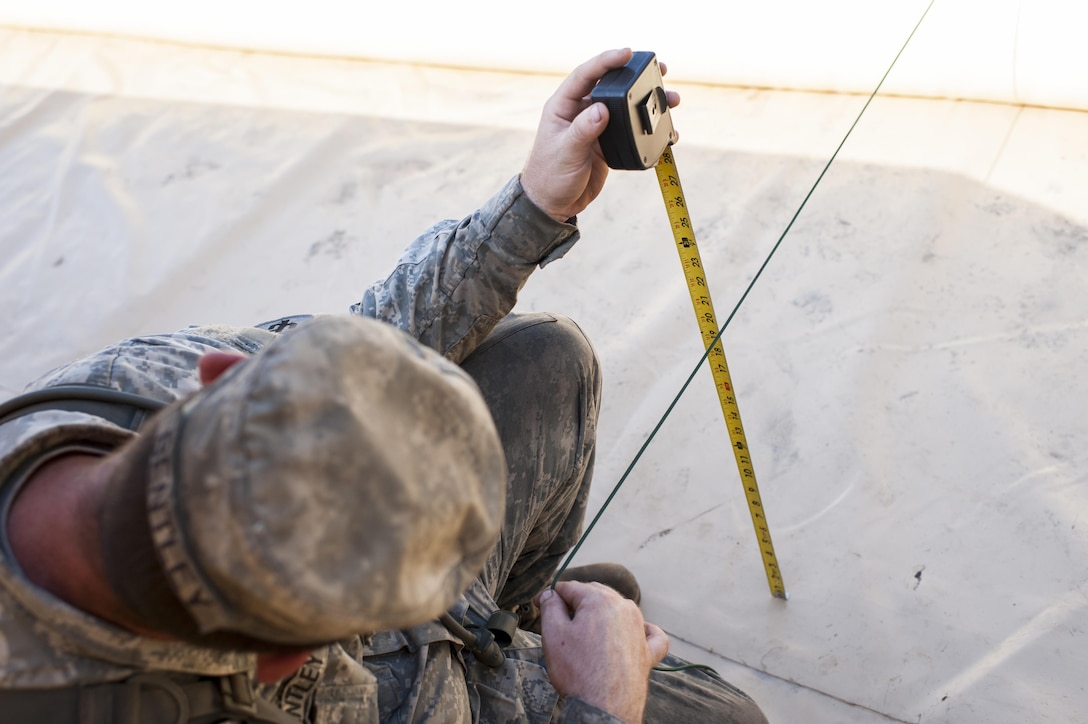 U.S. Army Reserve Spc. Dwayne Bentley, with the 431st Quartermaster Company, 103rd Expeditionary Sustainment Command, Battle Creek, Mich., measures the volume of a product in a 50K bag during QLLEX 2017, July 21, at Fort Bragg, NC. QLLEX, short for Quartermaster Liquid Logistics Exercise, is the U.S. Army Reserve’s premier readiness exercise for fuel and water distribution. This year’s QLLEX is not only a full demonstration of the capability, combat-readiness, and lethality of America’s Army Reserve to put fuel and water where it is needed most – in the vehicles and hands of the war-fighter and maneuver units – but it also further exercises the interoperability of the U.S. Army Reserve alongside active Army and British Army logisticians. (U.S. Army Reserve photo by Timothy L. Hale) (Released)