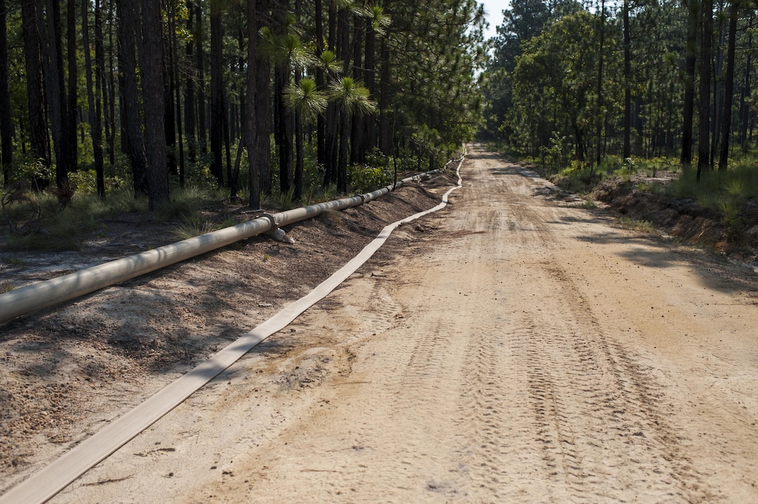 Approximately 4-miles of 6-inch hose were installed along existing firebreaks and tactical trails during QLLEX 2017, July 21, at Fort Bragg, NC. QLLEX, short for Quartermaster Liquid Logistics Exercise, is the U.S. Army Reserve’s premier readiness exercise for fuel and water distribution. This year’s QLLEX is not only a full demonstration of the capability, combat-readiness, and lethality of America’s Army Reserve to put fuel and water where it is needed most – in the vehicles and hands of the war-fighter and maneuver units – but it also further exercises the interoperability of the U.S. Army Reserve alongside active Army and British Army logisticians. (U.S. Army Reserve photo by Timothy L. Hale) (Released)