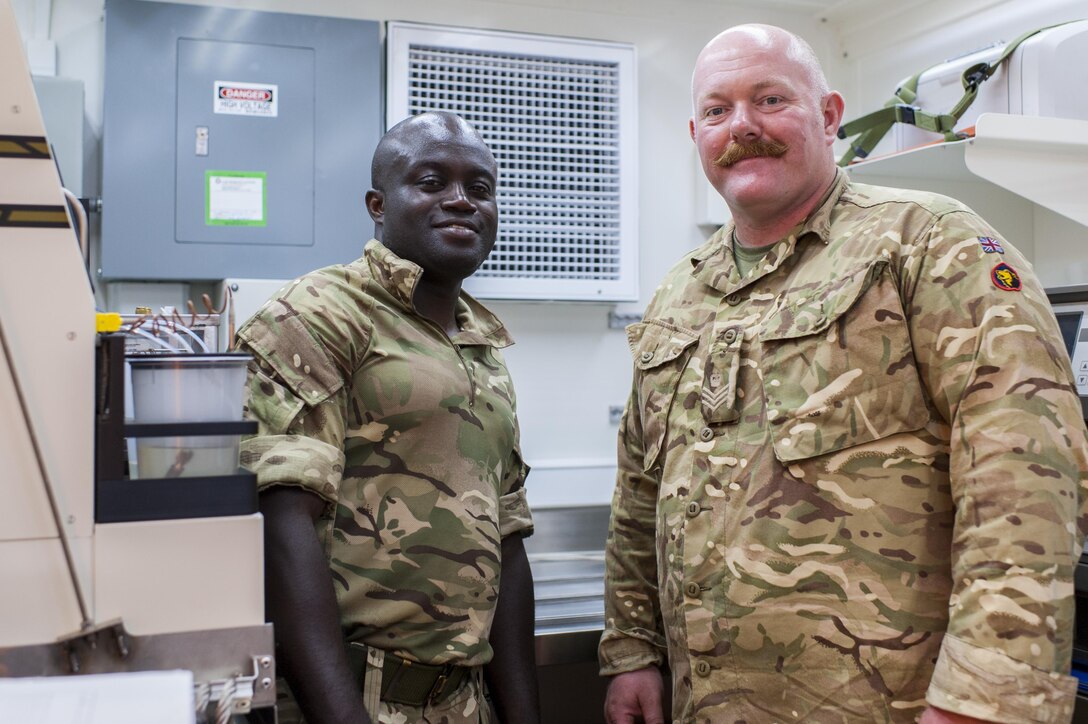 British Army logisticians, Staff Sgt. Samuel Korankye, left, and Staff Sgt. Barry Langley, both with the 152nd (North Irish) Regiment, Royal Logistics Corps, in Belfast, Northern Ireland, were attached the 53rd Quartermaster Company from Fort Hood, Texas, during QLLEX 2017, July 21, at Fort Bragg, NC. Langley, in the British Army Reserve, and Korankye, in the active British Army, were working with both U.S. Army Reserve and active Army logisticians during the QLLEX. QLLEX, short for Quartermaster Liquid Logistics Exercise, is the U.S. Army Reserve’s premier readiness exercise for fuel and water distribution. This year’s QLLEX is not only a full demonstration of the capability, combat-readiness, and lethality of America’s Army Reserve to put fuel and water where it is needed most – in the vehicles and hands of the war-fighter and maneuver units – but it also further exercises the interoperability of the U.S. Army Reserve alongside active Army and British Army logisticians. (U.S. Army Reserve photo by Timothy L. Hale) (Released)