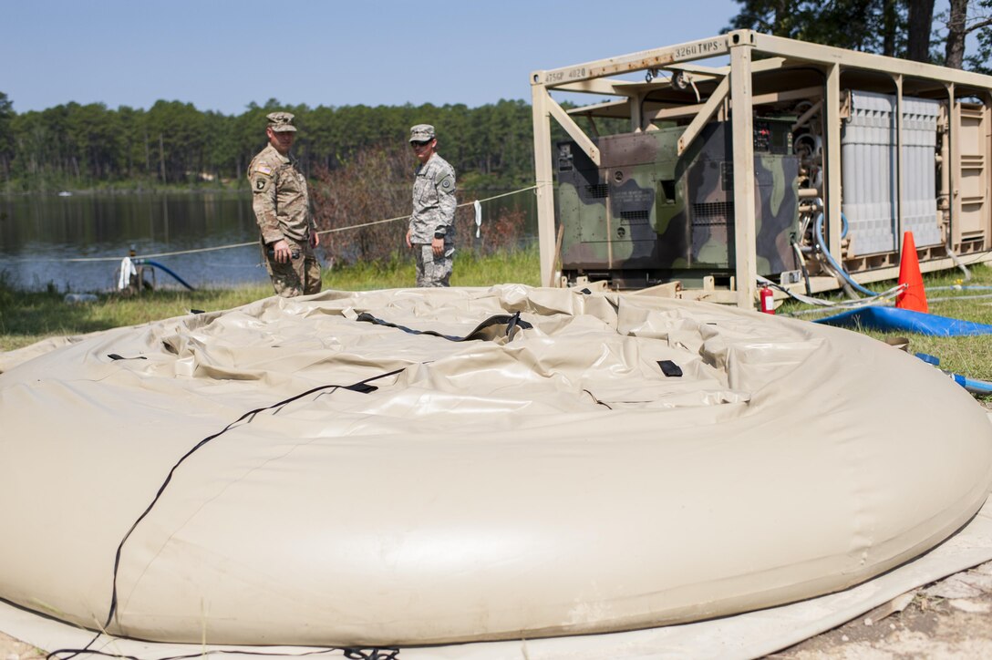U.S. Army Reserve Soldiers with the 326th Quartermaster Company, New Castle, Pa., check the progress of water filling a storage bag during QLLEX 2017, July 21, at Fort Bragg, NC. QLLEX, short for Quartermaster Liquid Logistics Exercise, is the U.S. Army Reserve’s premier readiness exercise for fuel and water distribution. This year’s QLLEX is not only a full demonstration of the capability, combat-readiness, and lethality of America’s Army Reserve to put fuel and water where it is needed most – in the vehicles and hands of the war-fighter and maneuver units – but it also further exercises the interoperability of the U.S. Army Reserve alongside active Army and British Army logisticians. (U.S. Army Reserve photo by Timothy L. Hale) (Released)