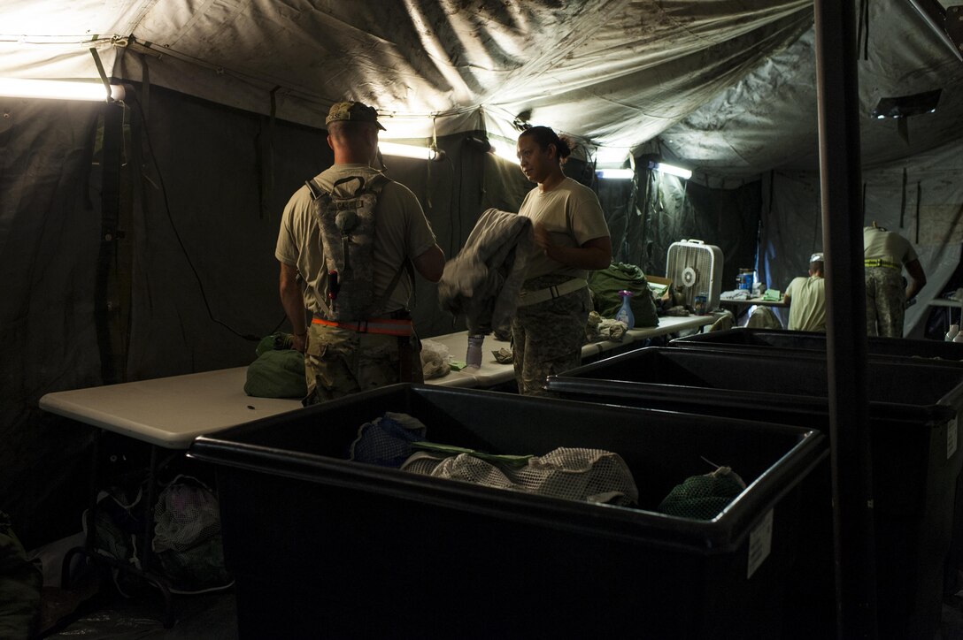U.S. Army Reserve Soldiers with the 275ht Quartermaster Company, Fort Pickett, Va., sort and fold clean laundry during QLLEX 2017, July 21, at Fort Bragg, NC. QLLEX, short for Quartermaster Liquid Logistics Exercise, is the U.S. Army Reserve’s premier readiness exercise for fuel and water distribution. This year’s QLLEX is not only a full demonstration of the capability, combat-readiness, and lethality of America’s Army Reserve to put fuel and water where it is needed most – in the vehicles and hands of the war-fighter and maneuver units – but it also further exercises the interoperability of the U.S. Army Reserve alongside active Army and British Army logisticians. (U.S. Army Reserve photo by Timothy L. Hale) (Released)