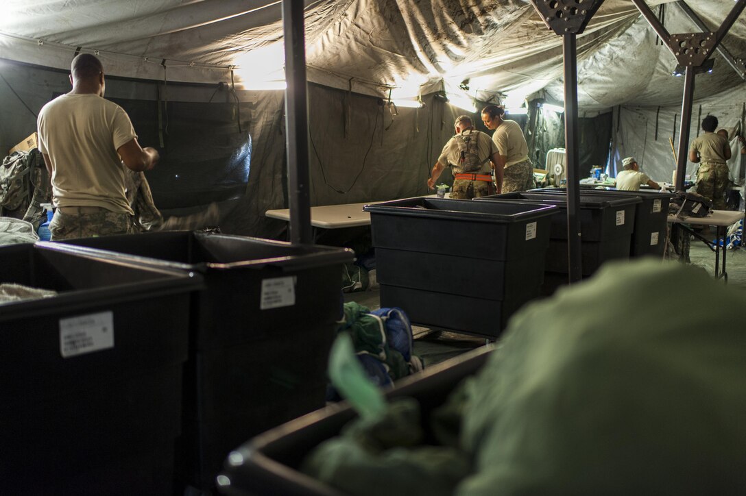 U.S. Army Reserve Soldiers with the 275ht Quartermaster Company, Fort Pickett, Va., sort and fold clean laundry during QLLEX 2017, July 21, at Fort Bragg, NC. QLLEX, short for Quartermaster Liquid Logistics Exercise, is the U.S. Army Reserve’s premier readiness exercise for fuel and water distribution. This year’s QLLEX is not only a full demonstration of the capability, combat-readiness, and lethality of America’s Army Reserve to put fuel and water where it is needed most – in the vehicles and hands of the war-fighter and maneuver units – but it also further exercises the interoperability of the U.S. Army Reserve alongside active Army and British Army logisticians. (U.S. Army Reserve photo by Timothy L. Hale) (Released)