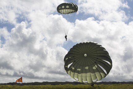 SCHOFIELD BARRACKS – Marines with 4th Force Reconnaissance Company land at a designated drop zone after conducting a static line airborne drop at Schofield Barracks, July 14, 2017. The Marines trained with U.S. Army Special Forces to maintain proficiency in completing static line and high altitude free fall airborne jumps. (U.S. Marine Corps photo by Lance Cpl. Isabelo Tabanguil)