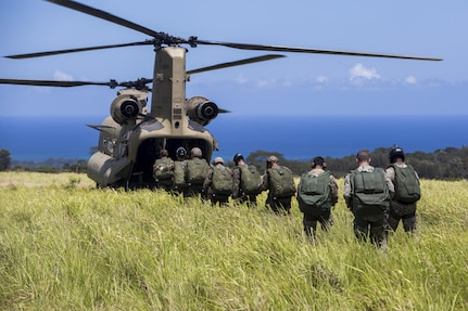 SCHOFIELD BARRACKS – Marines with 4th Force Reconnaissance Company and U.S. Army Special Forces soldiers board a CH-47 Chinook helicopter to conduct a high altitude airborne jump at Schofield Barracks, July 14, 2017. The Marines trained with U.S. Army Special Forces to maintain proficiency in completing static line and high altitude free fall airborne jumps. 