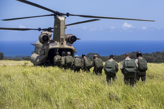 SCHOFIELD BARRACKS – Marines with 4th Force Reconnaissance Company and U.S. Army Special Forces soldiers board a CH-47 Chinook helicopter to conduct a high altitude airborne jump at Schofield Barracks, July 14, 2017. The Marines trained with U.S. Army Special Forces to maintain proficiency in completing static line and high altitude free fall airborne jumps. 