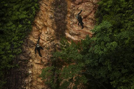 U.S. Marines with Alpha Company, 1st Battalion, 3rd Marine Regiment, rappel down a cliff at the Jungle Warfare Training Center aboard Camp Gonsalves, Okinawa, Japan, July 11, 2017. The Jungle Warfare Training Center provides individual and unit level training to increase survivability and lethality while operating in a jungle environment. The Hawaii-based battalion is forward deployed to Okinawa, Japan as part of the Unit Deployment Program. (U.S. Marine Corps photo by Cpl. Aaron S. Patterson)