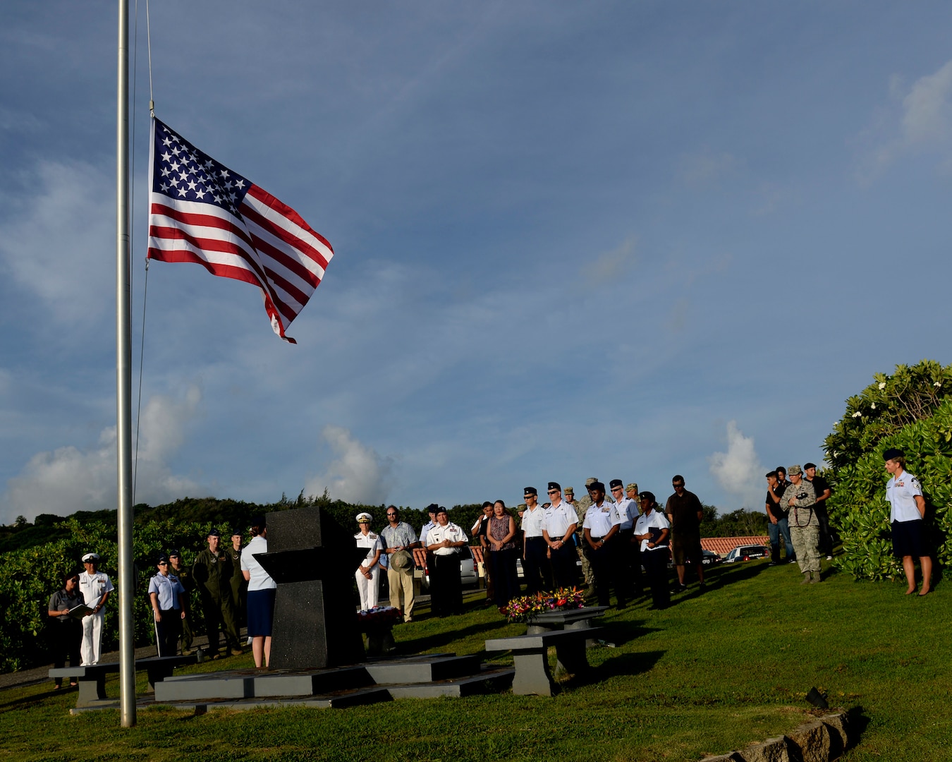Attendees of the RAIDR 21 memorial ceremony gather around the RAIDR 21 monument July 21, 2017, in Adelup, Guam. The monument honors the six B-52 Stratofortress crew members who lost their lives during a training mission July 21, 2008. The six aviators, from the 20th Expeditionary Bomb Squadron, were slated to participate in a flyover for Guam's Liberation Day Parade. (U.S. Air Force photo by Airman 1st Class Gerald R. Willis)