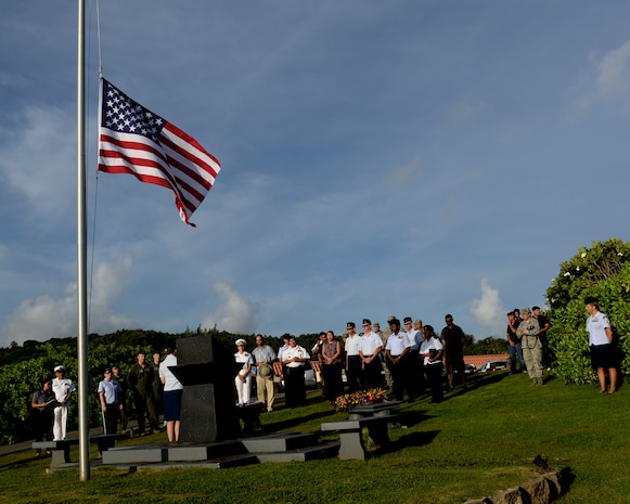 Attendees of the RAIDR 21 memorial ceremony gather around the RAIDR 21 monument July 21, 2017, in Adelup, Guam. The monument honors the six B-52 Stratofortress crew members who lost their lives during a training mission July 21, 2008. The six aviators, from the 20th Expeditionary Bomb Squadron, were slated to participate in a flyover for Guam's Liberation Day Parade. (U.S. Air Force photo by Airman 1st Class Gerald R. Willis)