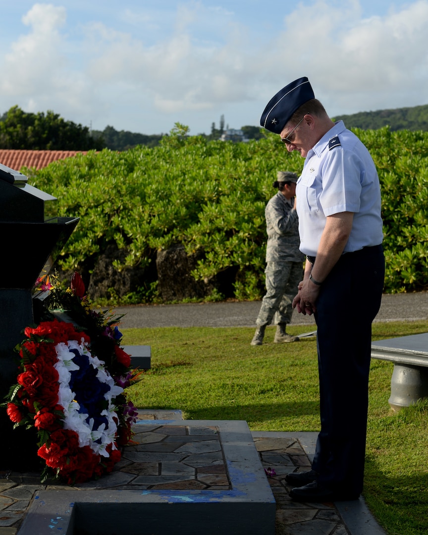 U.S. Air Force Brig. Gen. Douglas Cox, 36th Wing commander, pays respect to the crew members of RAIDR 21 July 21, 2017, in Adelup, Guam. The monument honors the six B-52 Stratofortress crew members who lost their lives July 21, 2008, during a training mission and were slated to perform a flyover in support of Guam’s Liberation Day. (U.S. Air Force photo by Airman 1st Class Gerald R. Willis)