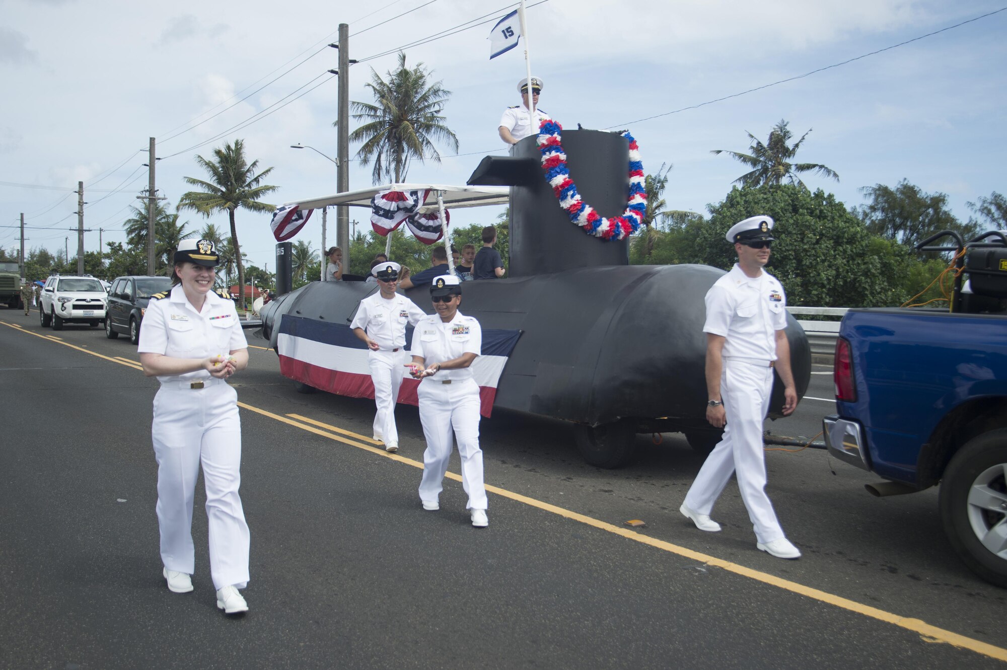 170721-N-JN506-036 HAGATNA, Guam (July 21, 2017) – Sailors from Commander, Submarine Squadron 15 march alongside the command submarine float and distribute candy during Guam's annual Liberation Day Parade in Hagatna, Guam, July 21. The 2017 Guam Liberation Parade celebrates the 73rd anniversary of the liberation of Guam from Japanese occupation by U.S. forces during World War II. (U.S. Navy photo by Mass Communication Specialist 1st Class Jamica Johnson/Released)