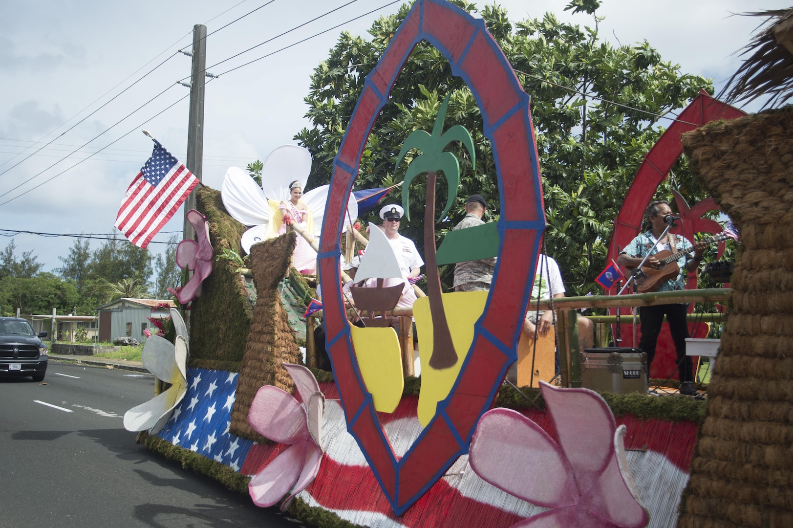 170721-N-JN506-025 HAGATNA, Guam (July 21, 2017) – Senior Chief Hospital Corpsman Michael Atkinson of Commander, Submarine Squadron 15 escorts his command's sister village of Inarajan's Royal Princess Gabriella Paulino Taitague during Guam's annual Liberation Day Parade in Hagatna, Guam, July 21. The 2017 Guam Liberation Parade celebrates the 73rd anniversary of the liberation of Guam from Japanese occupation by U.S. forces during World War II. (U.S. Navy photo by Mass Communication Specialist 1st Class Jamica Johnson/Released)