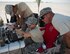 U.S. Air Force Senior Airman Luis Sandoval, left, Staff Sgt. Helen Daniel, and Tech. Sgt. Kevin Adams, Raven- B operators with 379th Expeditionary Security Forces Squadron, view the imagery received from the RQ-11 Raven at Al Udeid Air Base, Qatar, July 3, 2017. The RQ-11 Raven is a small unmanned aircraft system which provides real-time imagery or video for the 379th ESFS. (U.S. Air Force photo by Tech. Sgt. Amy M. Lovgren)
