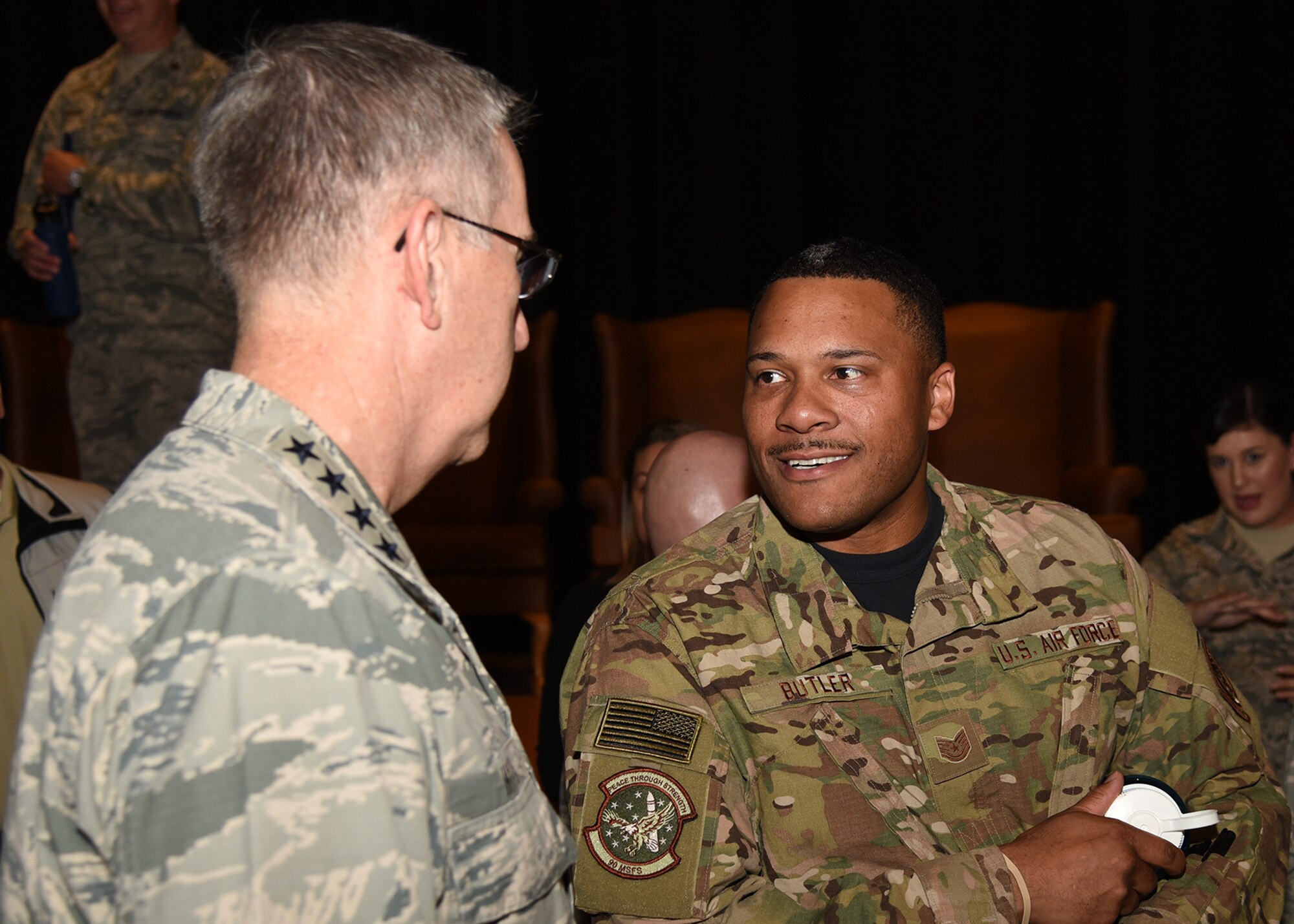 General John Hyten, commander of U.S. Strategic Command, talks with Tech Sgt. Pierce Butler from the 90th Mission Support Group, after an all-call at the F. E. Warren Air Force Base, Wyo., theater July 21, 2017. The Omaha Trophy is awarded to the best missile wing in USSTRATCOM. (U.S. Air Force photo by Glenn S. Robertson)