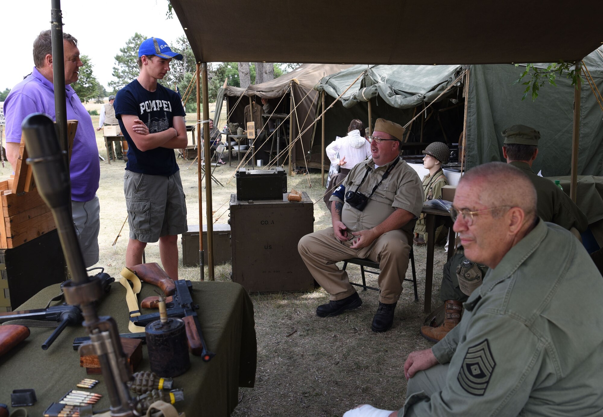 Scott Huff, a World War II re-enactor and photographer, talks about the history of Fort D.A. Russell Days at F.E. Warren Air Force Base, Wyo. July 21, 2017. In 1930, the fort's name was changed to Fort Francis E. Warren, and then to Francis E. Warren Air Force Base in 1949. This year marks the 150th anniversary of F.E. Warren Air Force Base, and the annual base open house brings military and civilian communities together to learn more about the base's rich history. (U.S. Air Force photo by Airman 1st Class Braydon Williams)