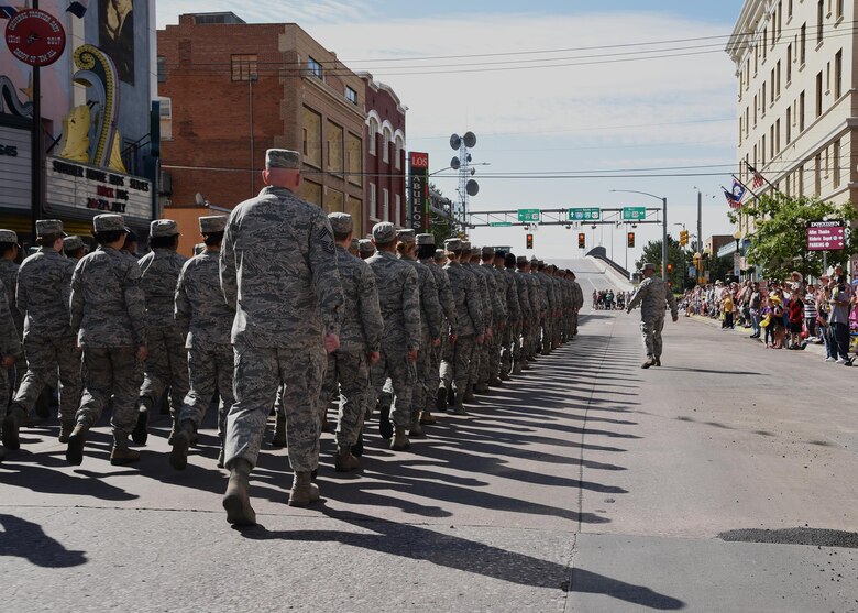Ninetieth Missile Wing Airmen march in a flight toward the Depot during the 121st Cheyenne Frontier Days opening grand parade in Cheyenne, Wyo., July 22, 2017. F.E. Warren Airmen volunteer in many capacities during CFD, Cheyenne's biggest annual event. This year marks the 150th anniversary of F.E. Warren Air Force Base and the city of Cheyenne. The two communities came together to celebrate during the 121st CFD rodeo and festival. (U.S. Air Force photo by Glenn S. Robertson) 