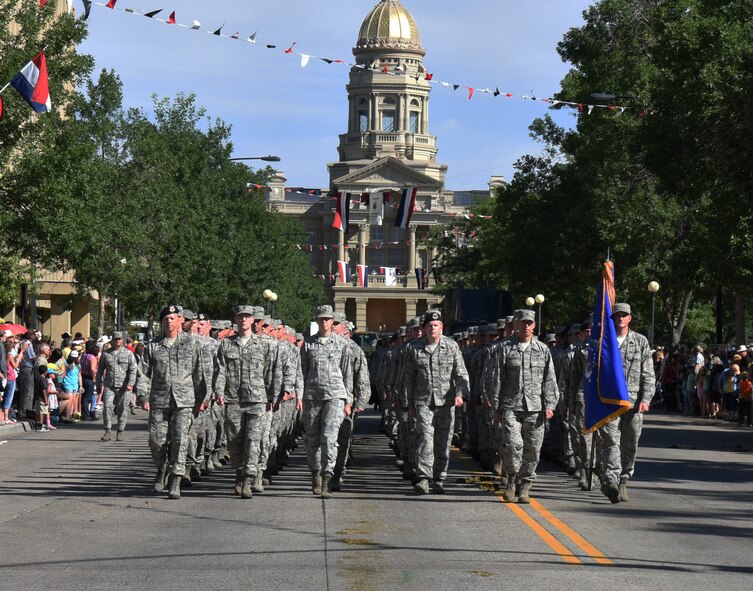 Airmen from the 90th Missile Wing march in formation during the 121st Cheyenne Frontier Days opening grand parade in Cheyenne, Wyo., July 22, 2017. Service members from multiple branches took part in the parade. This year marks the 150th anniversary of F.E. Warren Air Force Base and the city of Cheyenne. The two communities came together to celebrate during the 121st CFD rodeo and festival. (U.S. Air Force photo by Airman 1st Class Breanna Carter)