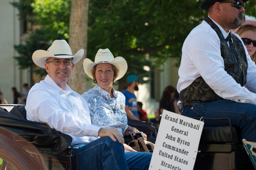 U.S. Air Force Gen. John E. Hyten, U.S. Strategic Command commander and his wife Laura, ride along Capitol Avenue during the 121st Cheyenne Frontier Days opening grand parade in Cheyenne, Wyo., July 22, 2017. Hyten was invited to be the grand marshal of the parade and opening ceremonies which officially mark the beginning of CFD. This year marks the 150th anniversary of F.E. Warren Air Force Base and the city of Cheyenne. The two communities came together to celebrate during the 121st CFD rodeo and festival. (U.S. Air Force photo by Staff Sgt. Christopher Ruano)
