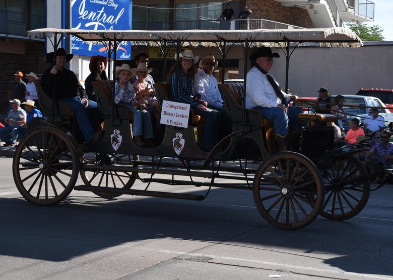 Col. Stacy Huser, 90th Missile Wing commander, smiles at the crowd while traveling down Capitol Avenue during the 121st Cheyenne Frontier Days opening grand parade in Cheyenne, Wyo., July 22, 2017. This is Huser’s first time attending the grand parade as the new 90th MW commander. This year marks the 150th anniversary of F.E. Warren Air Force Base and the city of Cheyenne. The two communities came together to celebrate during the 121st CFD rodeo and festival. (U.S. Air Force photo by Glenn S. Robertson)