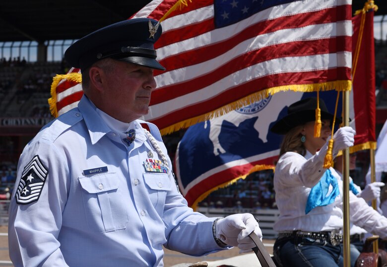 Chief Master Sgt. William G. Whipple, the command chief master sergeant to the adjutant general of Wyoming, rides in the grand entrance ceremony in Frontier Park during Cheyenne Frontier Days in Cheyenne, Wyo., July 22, 2017. The 121st Cheyenne Frontier Days kicks off with the entrance of the grand marshal. This year marks the 150th anniversary of F.E. Warren Air Force Base and the city of Cheyenne. The two communities came together to celebrate during the 121st CFD rodeo and festival. (U.S. Air Force photo by Airman 1st Class Braydon Williams)