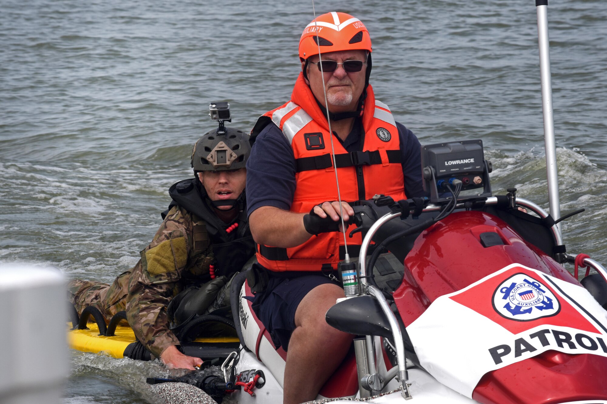 Master Sgt. James Henderson, 181st Weather Flight special operations weatherman, rides with a U.S. Coast Guard Auxiliary member to drop off his parachute gear after a deliberate water drop into Lake Worth in Fort Worth, Texas, May 20, 2017. The mission allowed 12 service members to parachute out of a C-130 Hercules from an altitude of 1000 feet into Lake Worth using MC-6 parachutes. (Texas Air National Guard photo by Staff Sgt. Kristina Overton)