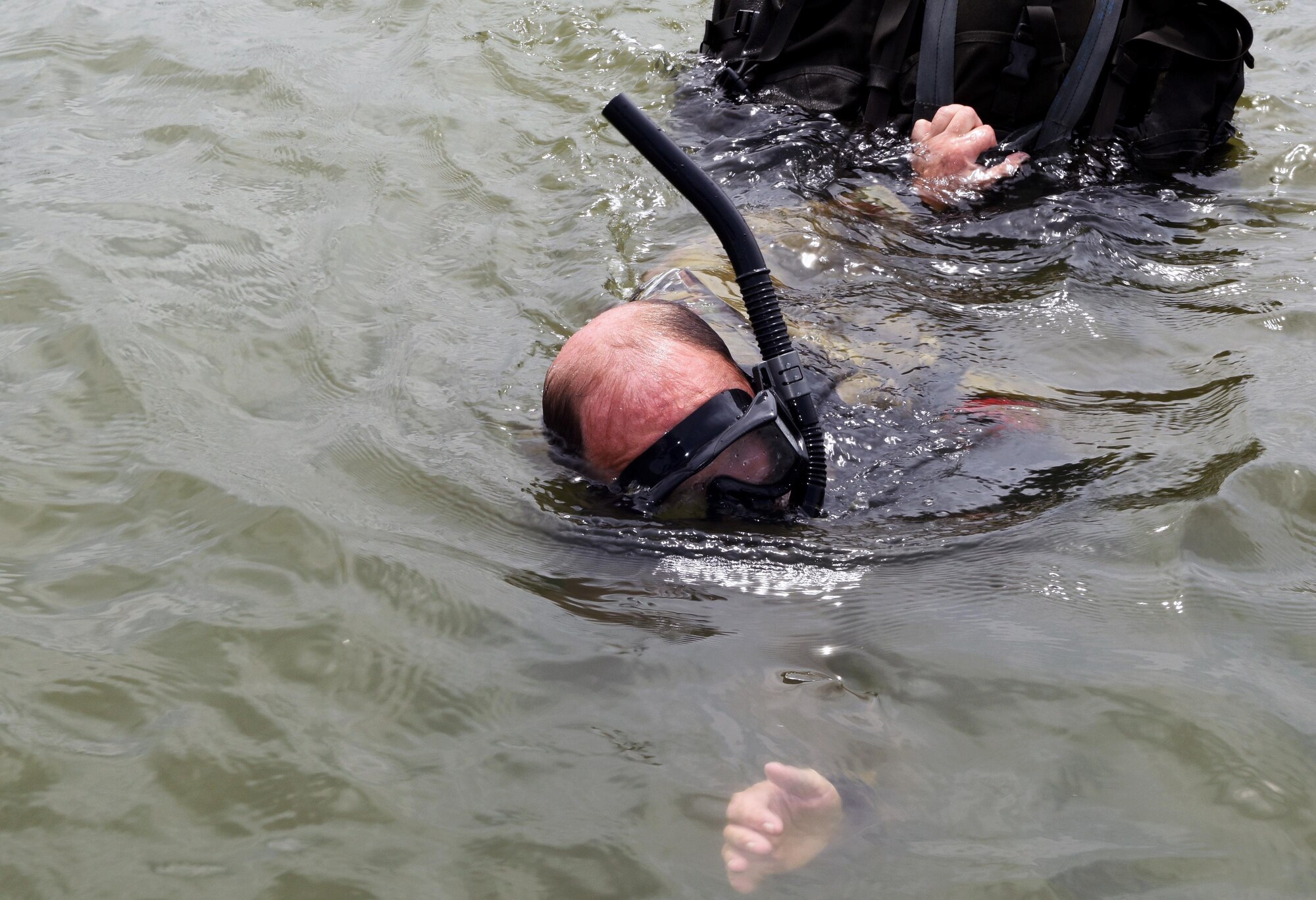 Master Sgt. Clinton Woodford, 181st Weather Flight special operations weatherman, swims to the recovery boat with his gear after a deliberate water drop into Lake Worth in Forth Worth, Texas,  May 20, 2017. The jump was part of an exercise to train on tactical skills when operating in hostile and denied territories. (Texas Air National Guard photo by Staff Sgt. Kristina Overton)