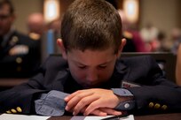 Elijah Daspit, son of Capt. Doug Daspit, U.S. Army Reserve chaplain for the 321st Sustainment Brigade, bows his head and prays during the opening invocation of this year’s Reserve Officers Association National Convention held in Crystal City, Virginia, July 22, 2017. During the convention, Daspit was awarded Chaplain of the Year for his response to recent Baton Rouge floods, providing one-on-one pastoral counseling to 38 Soldiers and their affected families. (U.S. Army Reserve photo by Sgt. Audrey Hayes)