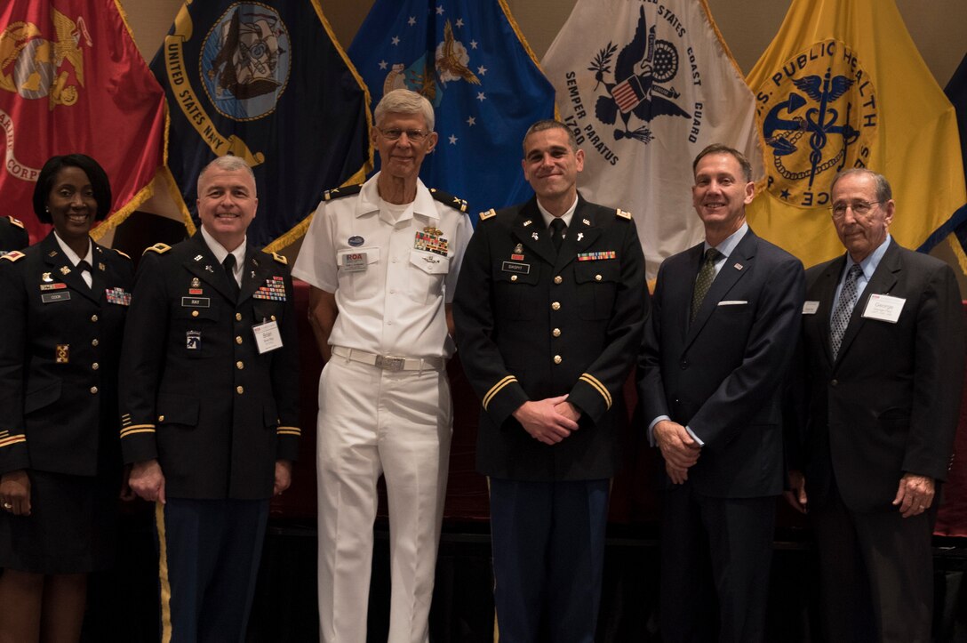 Capt. Doug Daspit (fourth from left), U.S. Army Reserve chaplain for the 321st Sustainment Brigade located in Baton Rouge, Louisiana, smiles for a picture after receiving the Chaplain of the Year award during the Reserve Officers Association National Convention in Crystal City, Virginia, July 22, 2017. Daspit was nominated for his response to recent Baton Rouge floods, providing one-on-one pastoral counseling to 38 Soldiers and their affected families. (U.S. Army Reserve photo by Sgt. Audrey Hayes)