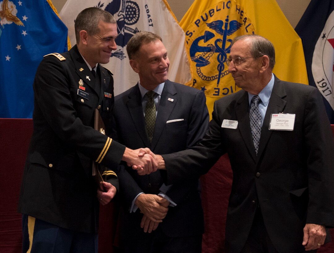 Capt. Doug Daspit, U.S. Army Reserve chaplain for the 321st Sustainment Brigade located in Baton Rouge, Louisiana, shakes hands with chaplain endorser, George Paul, after receiving the Chaplain of the Year award during the Reserve Officers Association National Convention in Crystal City, Virginia, July 22, 2017. Daspit was nominated for his response to recent Baton Rouge floods, providing one-on-one pastoral counseling to 38 Soldiers and their affected families. (U.S. Army Reserve photo by Sgt. Audrey Hayes)