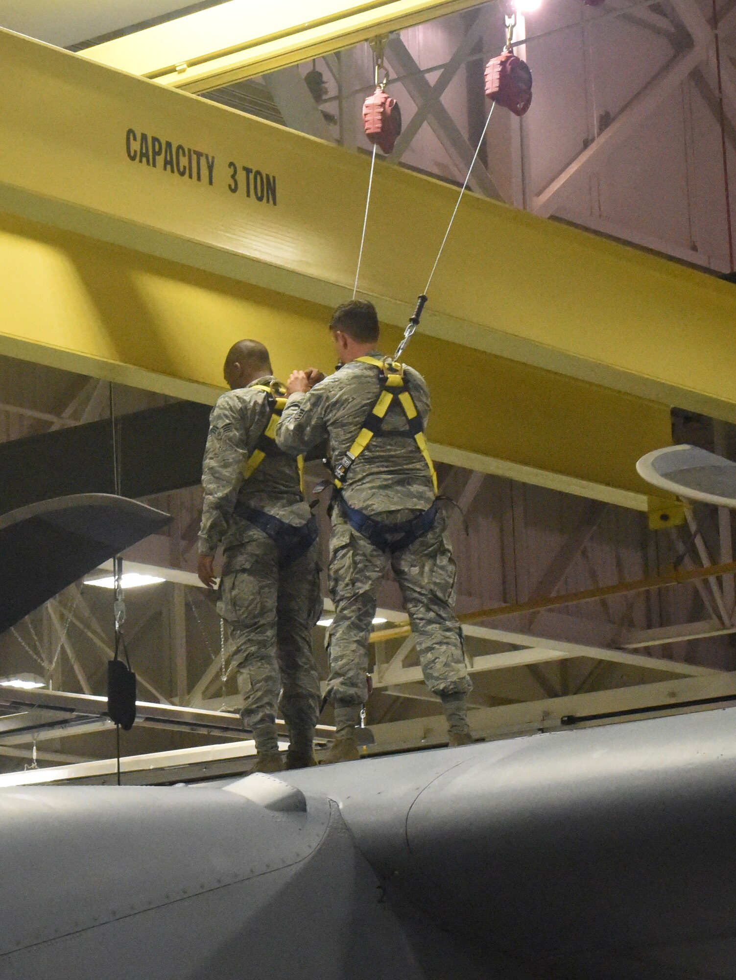 Staff Sgt. Michael Harlow (right) and Senior Airman Lance McDonald, aerospace maintainers with the 193rd Special Operations Wing, Middletown, Pennsylvania, ensure safety procedures are in place before inspecting an aircraft July 23, 2017. This aircraft inspection included a routine check of the No. 2 dry bay and the vertical boot. (U.S. Air National Guard photo by Senior Airman Julia Sorber/Released) 