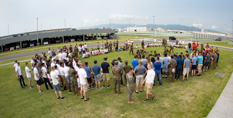 U.S. Marines with Marine Aviation Logistics Squadron (MALS) 12 grapple at Marine Corps Air Station Iwakuni, Japan, July 21, 2017. The USO hosted a field meet and cookout for MALS-12, which included several competitions such as grappling, pull-ups and a Humvee pull. (U.S. Marine Corps photo by Lance Cpl. Jacob A. Farbo)