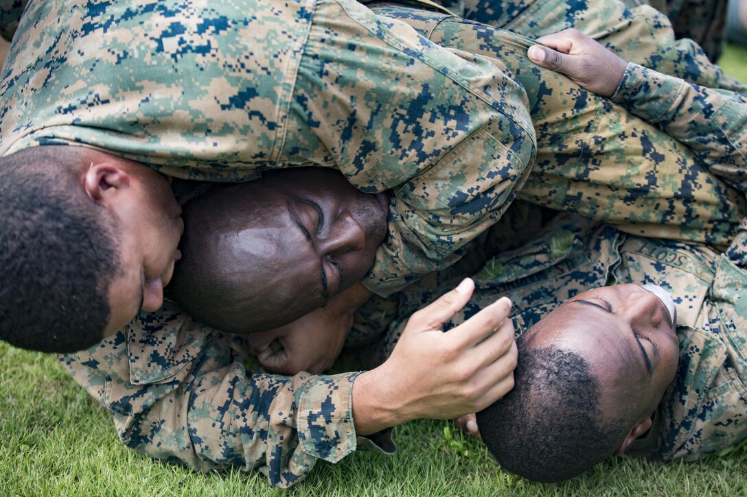 U.S. Marines with Marine Aviation Logistics Squadron (MALS) 12 grapple at Marine Corps Air Station Iwakuni, Japan, July 21, 2017. The USO hosted a field meet and cookout for MALS-12, which included several competitions such as grappling, pull-ups and a Humvee pull. (U.S. Marine Corps photo by Lance Cpl. Jacob A. Farbo)