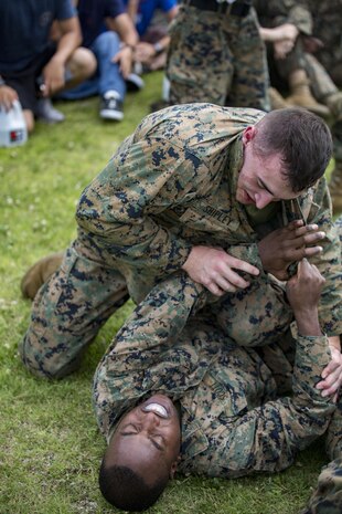 U.S. Marines with Marine Aviation Logistics Squadron (MALS) 12 grapple at Marine Corps Air Station Iwakuni, Japan, July 21, 2017. The USO hosted a field meet and cookout for MALS-12, which included several competitions such as grappling, pull-ups and a Humvee pull. (U.S. Marine Corps photo by Lance Cpl. Jacob A. Farbo)
