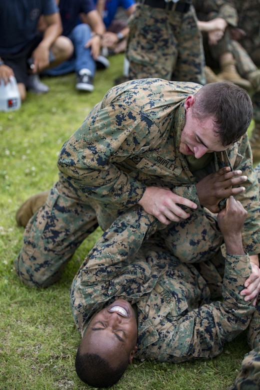 U.S. Marines with Marine Aviation Logistics Squadron (MALS) 12 grapple at Marine Corps Air Station Iwakuni, Japan, July 21, 2017. The USO hosted a field meet and cookout for MALS-12, which included several competitions such as grappling, pull-ups and a Humvee pull. (U.S. Marine Corps photo by Lance Cpl. Jacob A. Farbo)