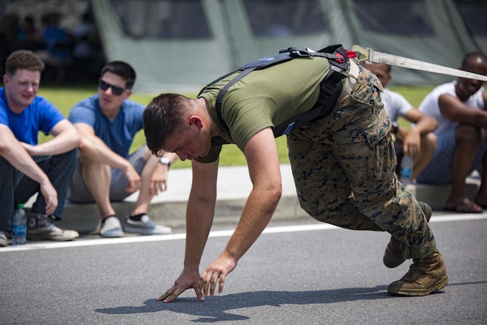 U.S. Marines with Marine Aviation Logistics Squadron (MALS) 12 pull a Humvee at Marine Corps Air Station Iwakuni, Japan, July 21, 2017. The USO hosted a field meet and cookout for MALS-12, which included several competitions such as grappling, pull-ups and a Humvee pull. (U.S. Marine Corps photo by Lance Cpl. Jacob A. Farbo)