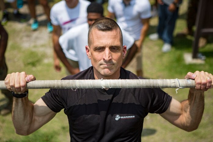 U.S. Marines with Marine Aviation Logistics Squadron (MALS) 12 perform pull ups at Marine Corps Air Station Iwakuni, Japan, July 21, 2017. The USO hosted a field meet and cookout for MALS-12, which included several competitions such as grappling, pull-ups and a Humvee pull. (U.S. Marine Corps photo by Lance Cpl. Jacob A. Farbo)