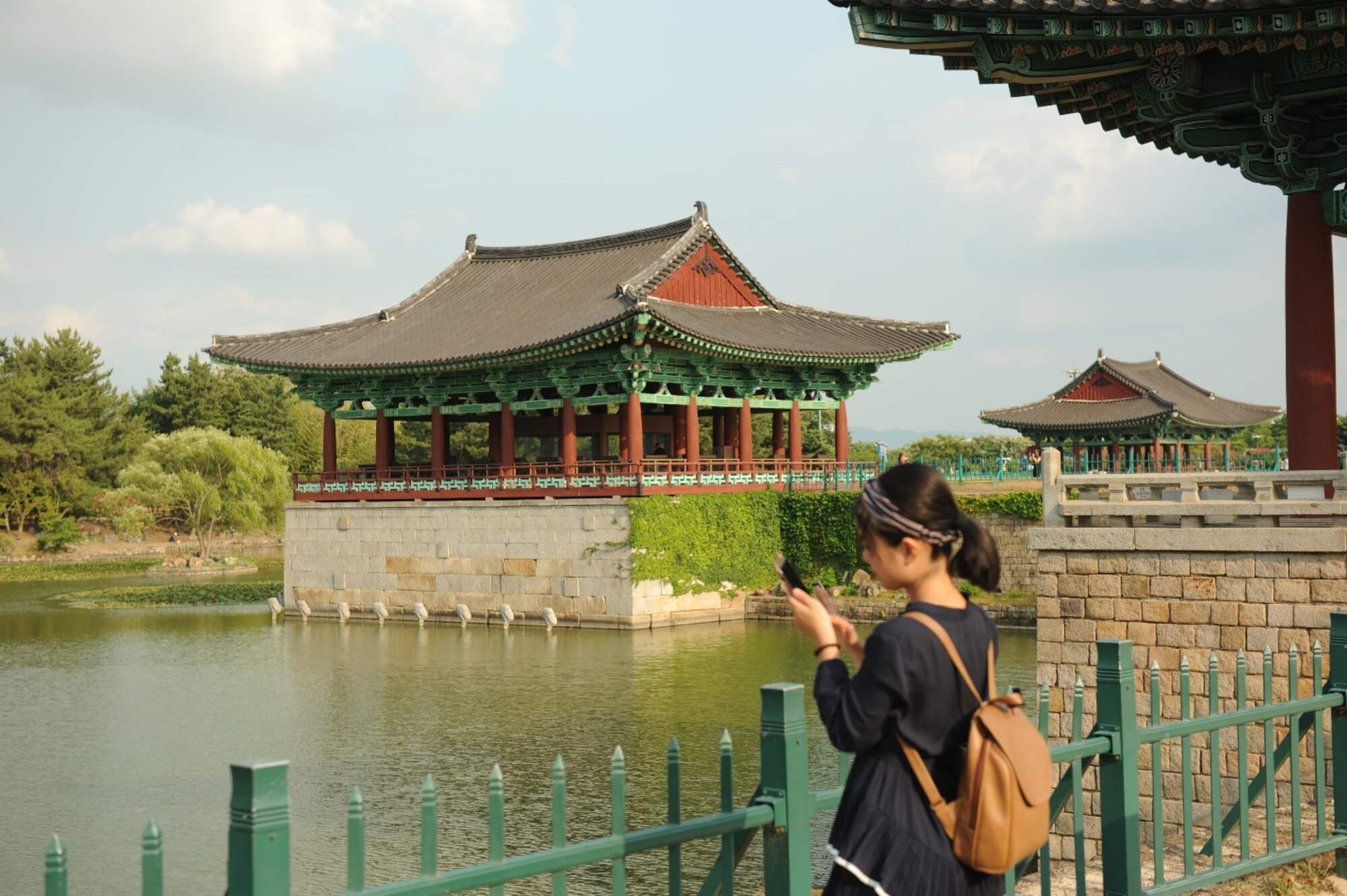 A visitor of the Donggung Palace and Wolji Pond takes a photo in Gyeongju, Republic of Korea, July 18, 2017. The Donggung Palace was built in 57 BCE and was a secondary palace, used for banquets and important national events. Nearly 100 United States Forces Korea members were invited by the Ministry of Patriots and Veterans Affairs to tour this location and other historic sites across the ROK as part of an initiative to give U.S. personnel a better understanding of Korean culture and patriotism. (U.S. Air Force photo by 1st Lt. Lauren Linscott/Released)