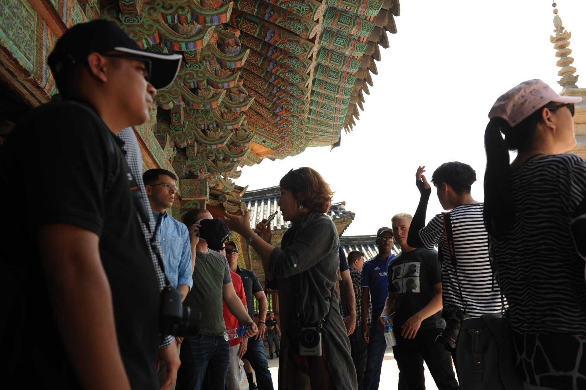 A Bulguksa Temple tour guide provides the history and significance of the temple and surrounding structures to United States Forces Korea members in Gyeongju, Republic of Korea, July 19, 2017. The temple was constructed under the Silla kingdom in 528 and is known for its stone pagodas. Nearly 100 USFK members were invited by the Ministry of Patriots and Veterans Affairs to tour this location and other historic sites across the ROK as part of an initiative to give U.S. personnel a better understanding of Korean culture and patriotism. (U.S. Air Force photo by 1st Lt. Lauren Linscott/Released)
