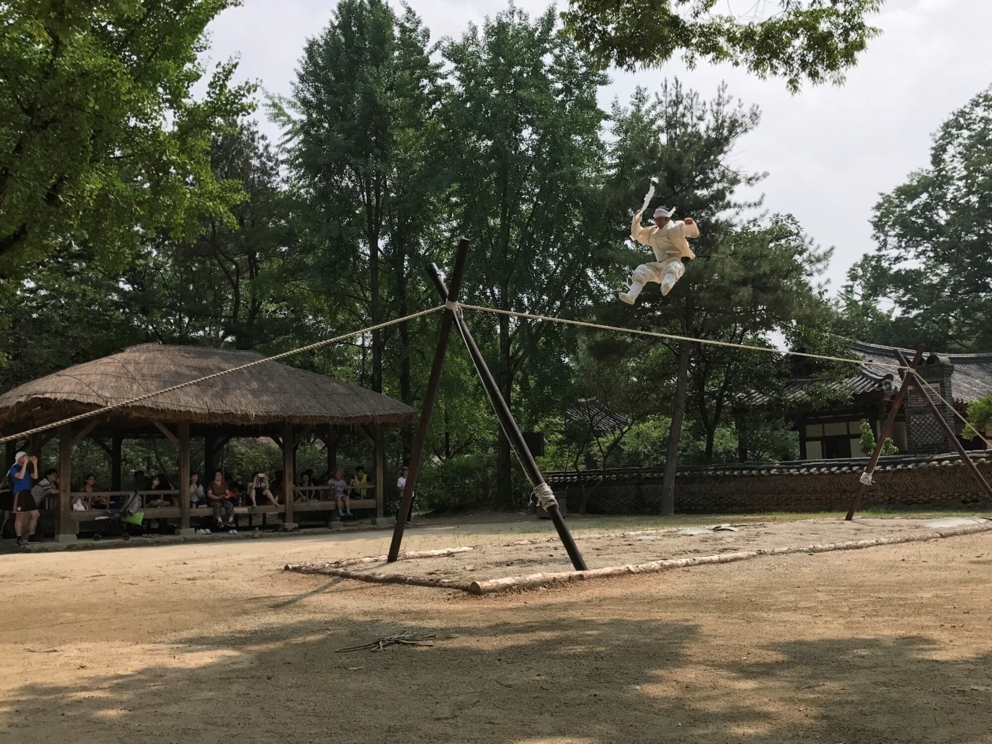 An acrobat performs a tightrope walking routine at the Korean Folk Village in Yongin, Republic of Korea, July 20, 2017. The Korean Folk Village hosts performances of traditional art forms from the Joseon Dynasty period to connect the past to the present. Nearly 100 United States Forces Korea members were invited by the Ministry of Patriots and Veterans Affairs to tour this location and other historic sites across the ROK as part of an initiative to give U.S. personnel a better understanding of Korean culture and patriotism. (U.S. Air Force photo by 1st Lt. Lauren Linscott/Released) 
