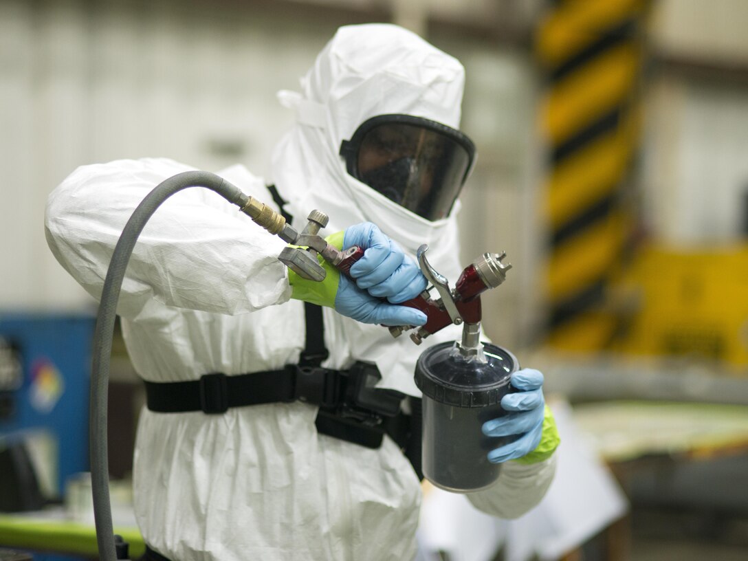 U.S. Air Force Senior Airman William Williams, 51st Maintenance Squadron sheet metal and corrosion technician, loads a paint sprayer in the corrosion shop Osan Air Base, Republic of Korea, June 20, 2017. Williams was one of the members of Corrosion Control who expertly painted the 36th Fighter Squadron Flying Fiends Centennial F-16 Fighting Falcon. (U.S. Air Force photo by Staff Sgt. Alex Fox Echols III)